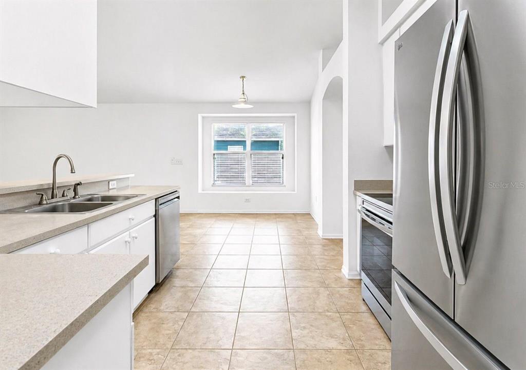 10725 Deepbrook Drive Riverview, FL 33569 - Photo 20 of 67 a kitchen with stainless steel appliances a sink stove and a refrigerator