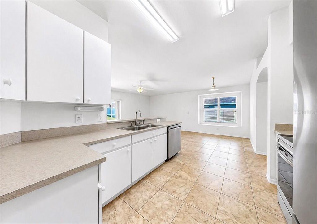 10725 Deepbrook Drive Riverview, FL 33569 - Photo 21 of 67 a kitchen with granite countertop a stove a sink and a refrigerator
