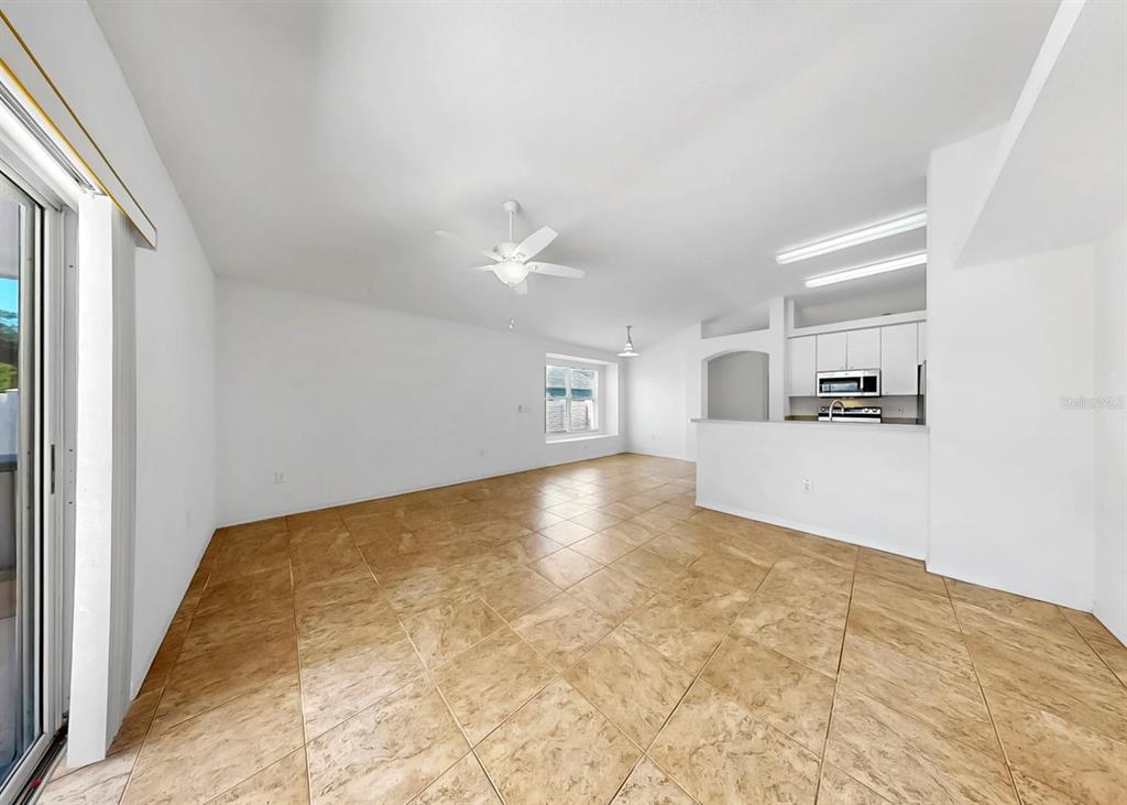 10725 Deepbrook Drive Riverview, FL 33569 - Photo 28 of 67 a view of a kitchen with kitchen island a sink wooden floor and living room view