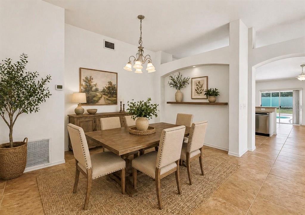 10725 Deepbrook Drive Riverview, FL 33569 - Photo 51 of 67 a view of a dining room with furniture and chandelier