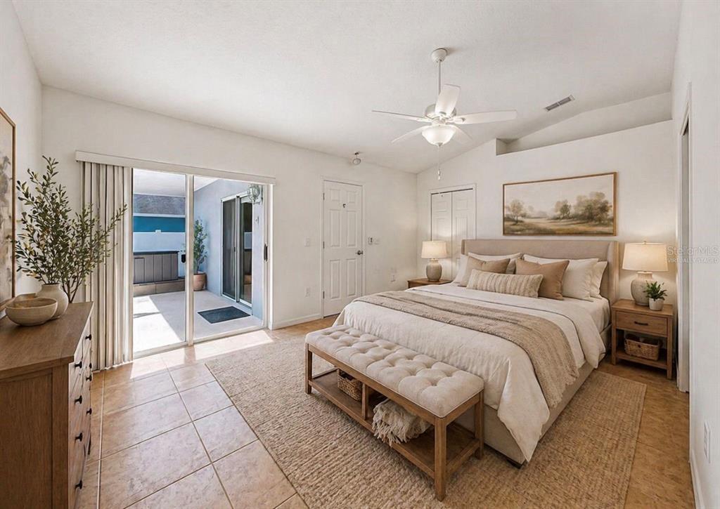 10725 Deepbrook Drive Riverview, FL 33569 - Photo 57 of 67 a spacious bedroom with a large bed a chandelier and closet