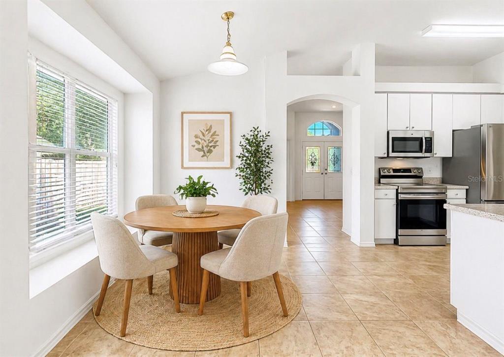 10725 Deepbrook Drive Riverview, FL 33569 - Photo 60 of 67 a view of a dining room with furniture a chandelier and wooden floor