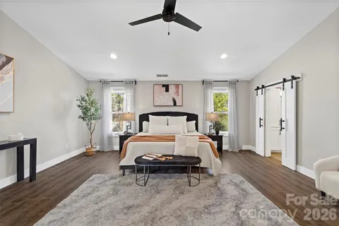 a spacious bedroom with a bed a couch and a window