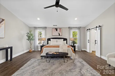 a spacious bathroom with a double vanity sink a large mirror and shower