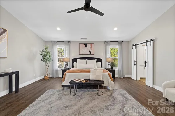 a spacious bathroom with a double vanity sink a large mirror and shower