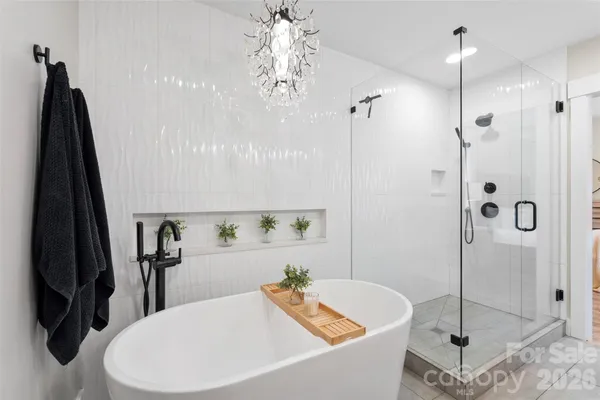 a bathroom with a tub sink and mirror