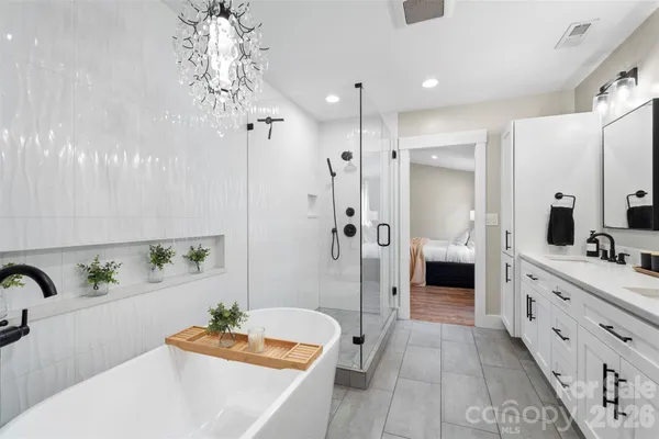a bathroom with a double vanity sink a toilet and a large mirror