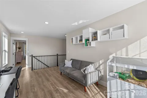 a bedroom with two beds and painting on the wall