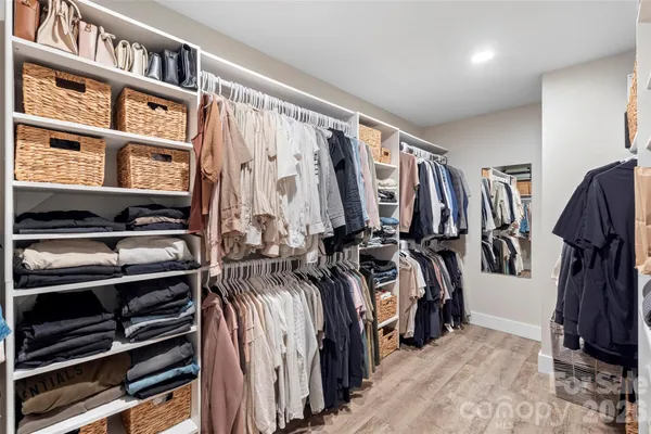 a bedroom with bed and wooden floor