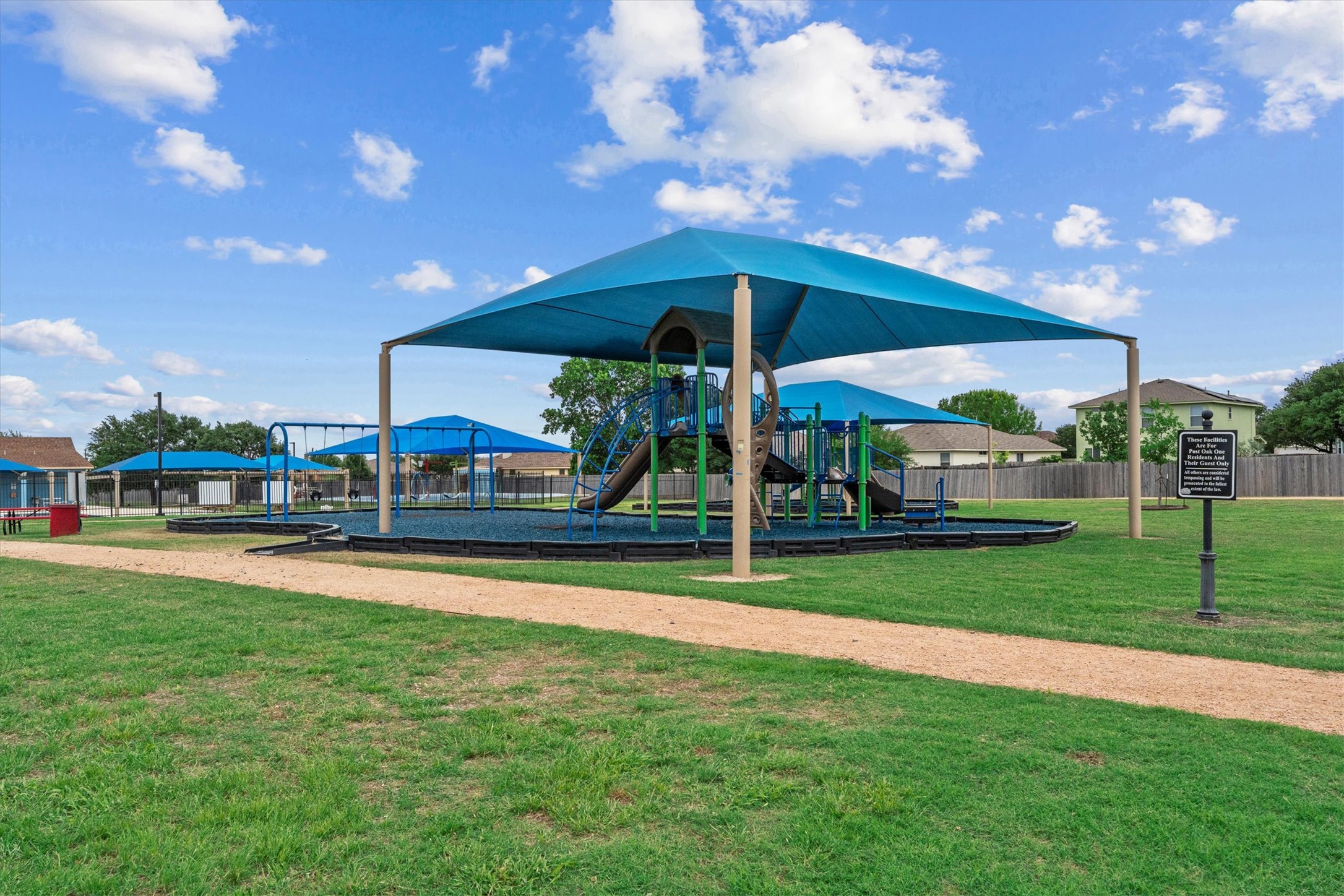 172 Discovery Kyle, TX 78640 - Photo 20 of 21 Beautiful community park featuring walking paths, playground equipment, and shaded gathering areas.
