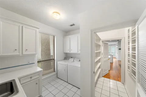 a kitchen with a sink and refrigerator