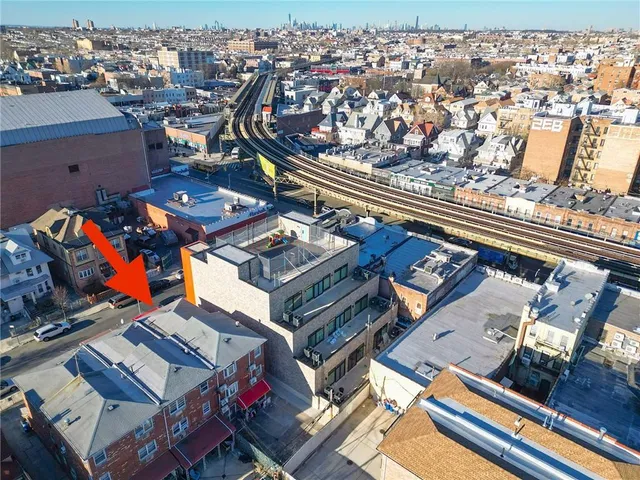 an aerial view of a building with glass windows