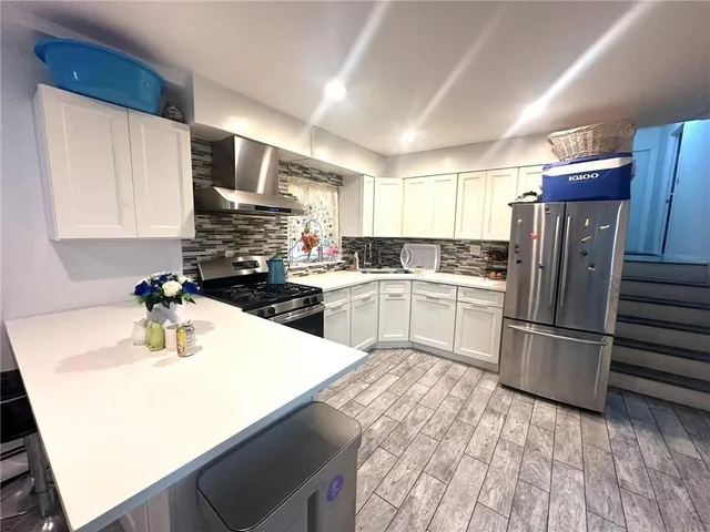 a kitchen with a refrigerator sink and microwave
