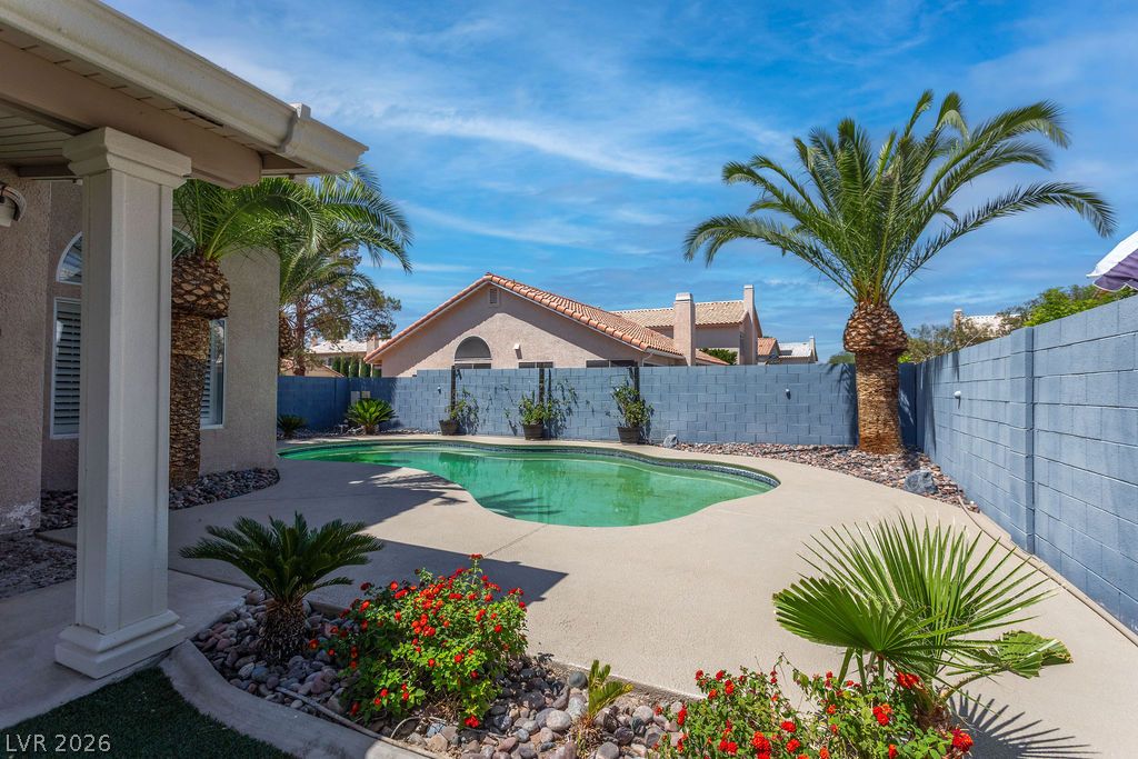 1416 Walstone Road North Las Vegas, NV 89031 - Photo 44 of 47 An inviting backyard oasis offers a freeform pool surrounded by desert-adapted landscaping.