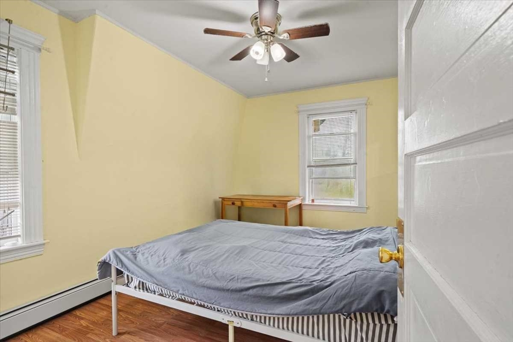 3 Wallace Street Worcester, MA 01605 - Photo 17 of 29 a bedroom with a bed and a window