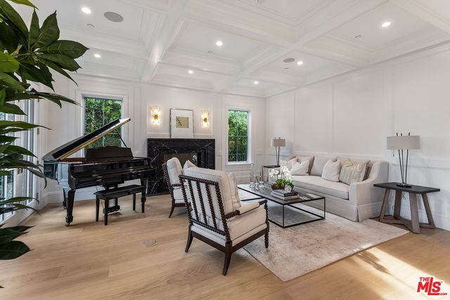 a living room with furniture and a piano