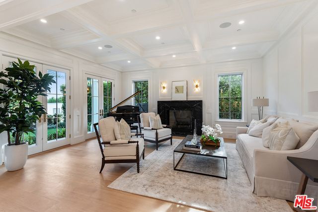 a living room with furniture rug and a fireplace