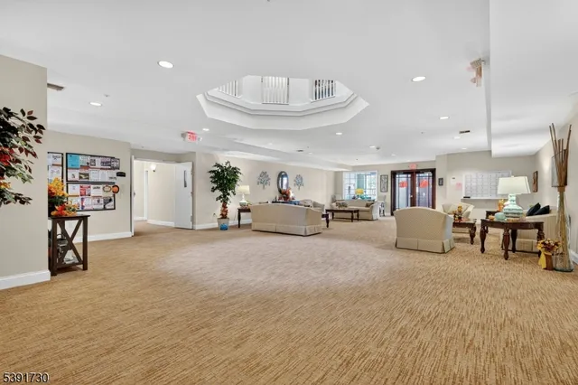 a living room with furniture and a book shelf