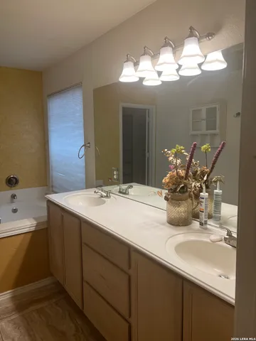 a bed sitting in a bedroom next to a lamp