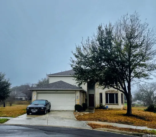 a front view of a house with trees