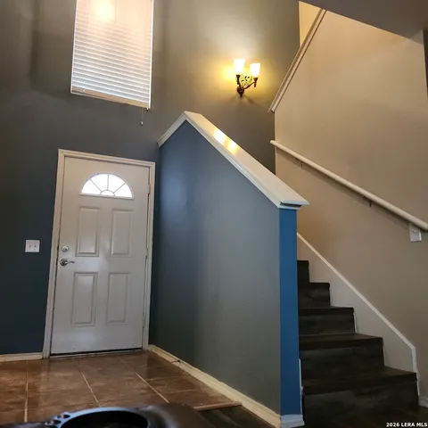 a view of a livingroom with wooden floor and stairs