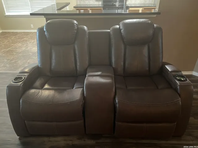 an empty room with a wooden floor and windows