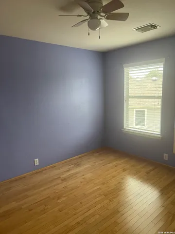 a view of an empty room with a fan