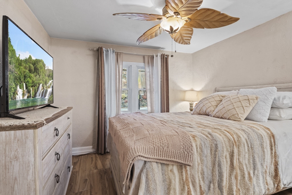 170 Stafford Street Worcester, MA 01603 - Photo 15 of 29 a bedroom with a bed and a chandelier