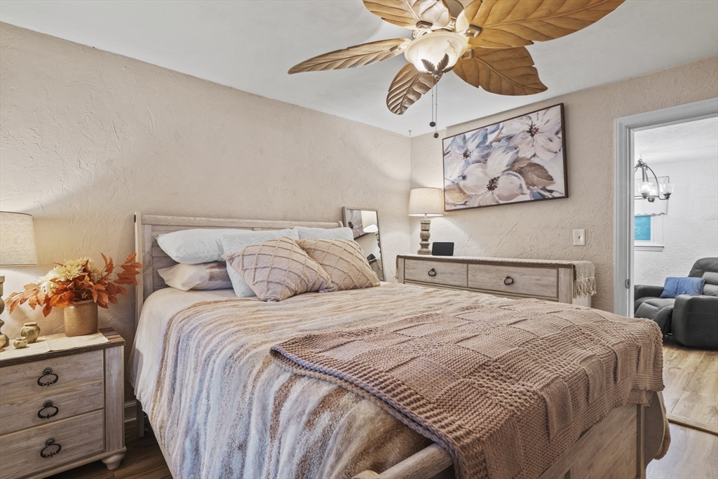 170 Stafford Street Worcester, MA 01603 - Photo 17 of 29 a bedroom with a bed and a chandelier