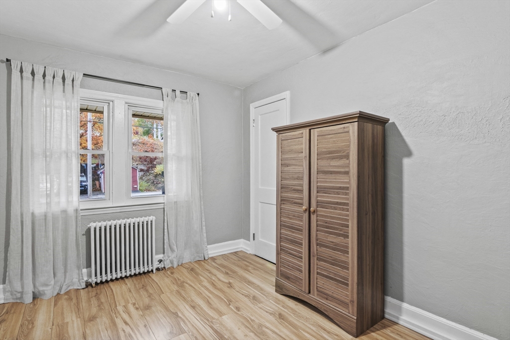 170 Stafford Street Worcester, MA 01603 - Photo 21 of 29 an empty room with wooden floor and windows