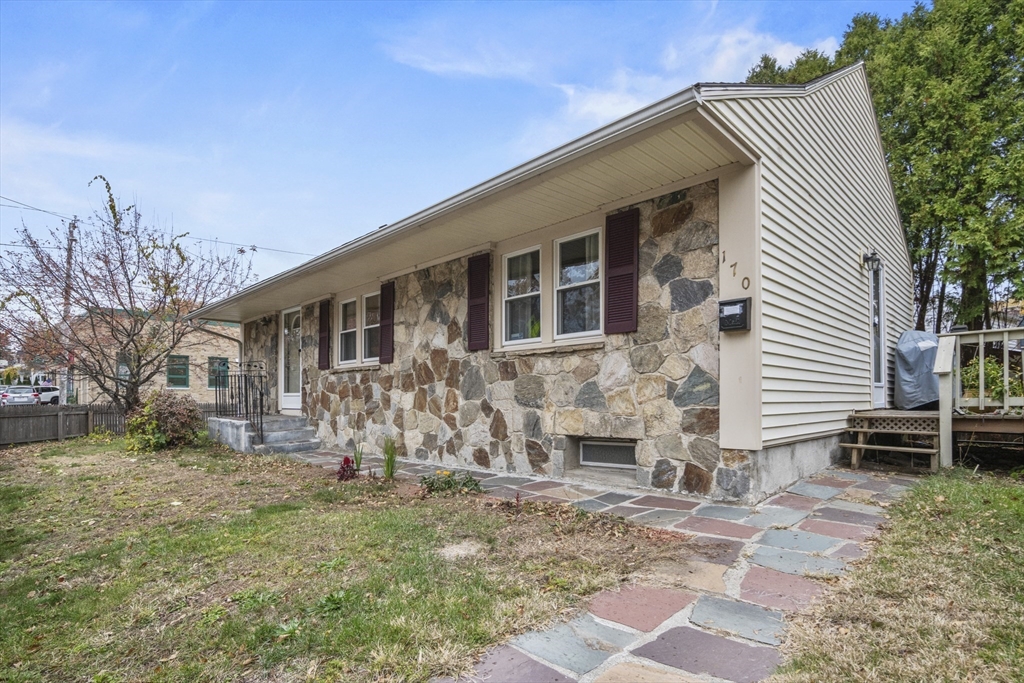 170 Stafford Street Worcester, MA 01603 - Photo 3 of 29 a front view of a house with a yard