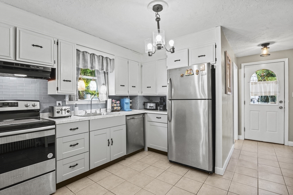 170 Stafford Street Worcester, MA 01603 - Photo 4 of 29 a kitchen with stainless steel appliances a refrigerator sink and cabinets