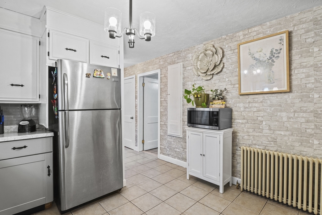 170 Stafford Street Worcester, MA 01603 - Photo 6 of 29 a kitchen with stainless steel appliances granite countertop a refrigerator a stove and a sink