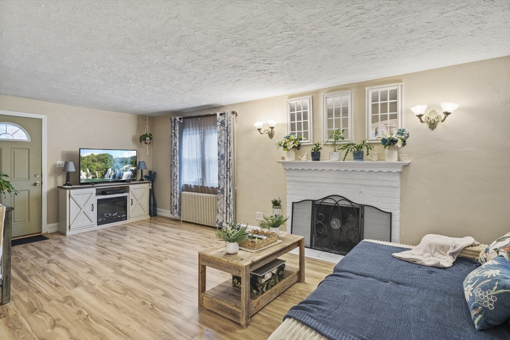 170 Stafford Street Worcester, MA 01603 - Photo 10 of 29 a living room with furniture and a fireplace