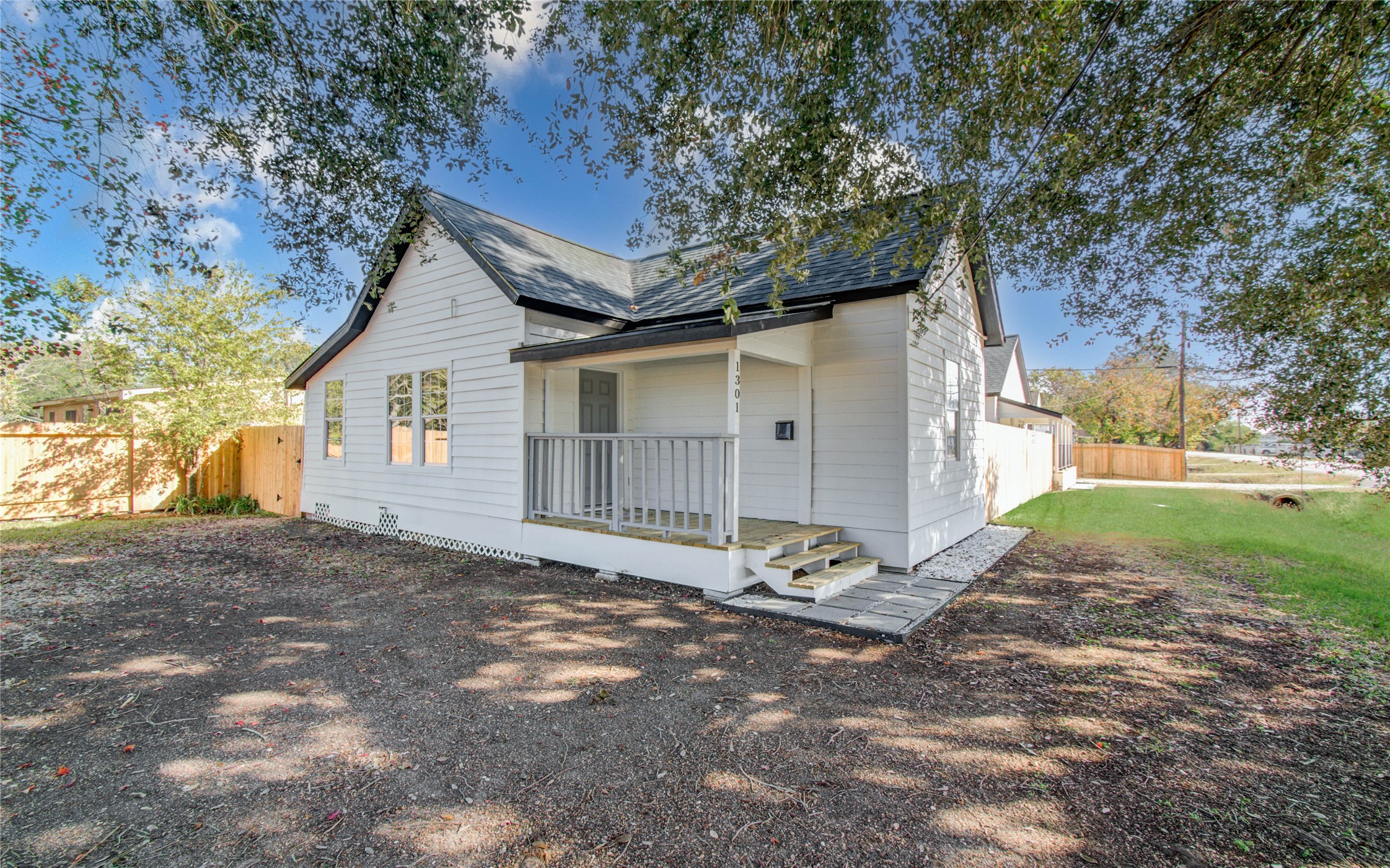 a view of a house with backyard and a tree