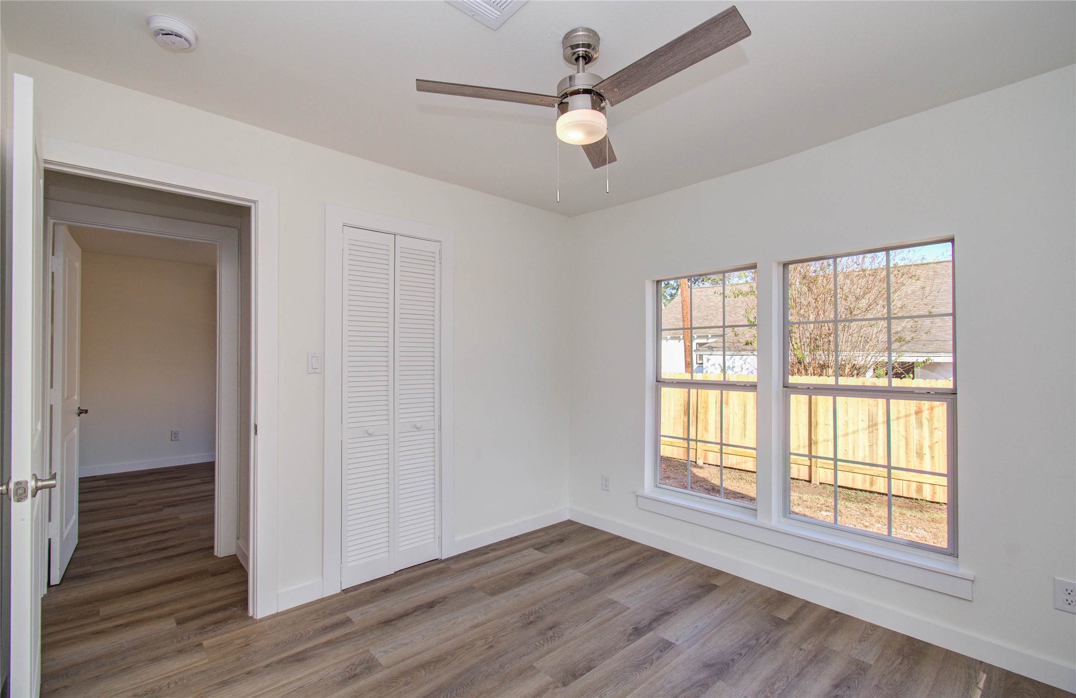 1301 Southgate Drive Rosenberg, TX 77471 - Photo 18 of 49 a view of an empty room with wooden floor and a window