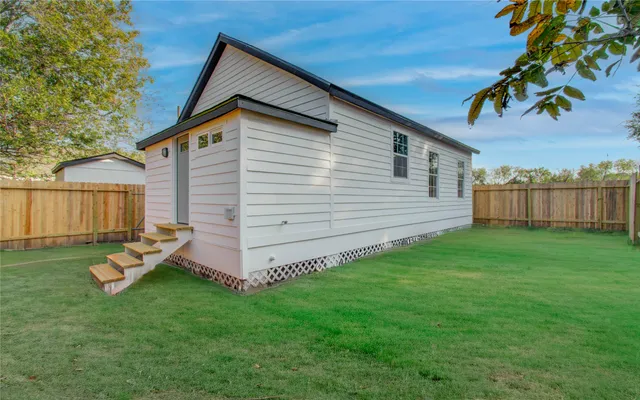 a view of entryway with wooden floor and fence