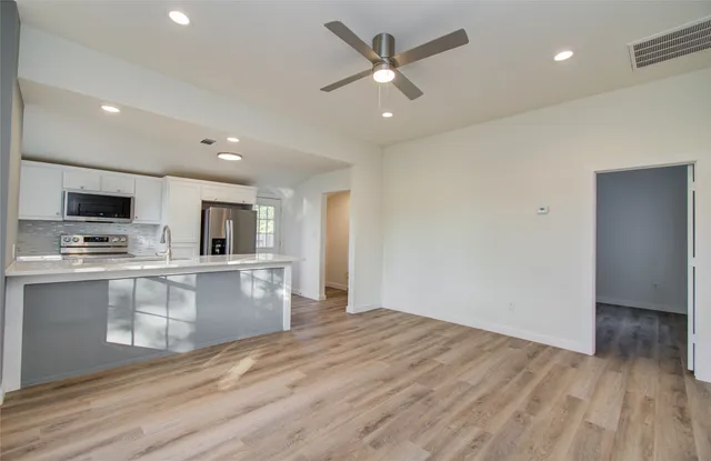 a kitchen that has a sink and a stove