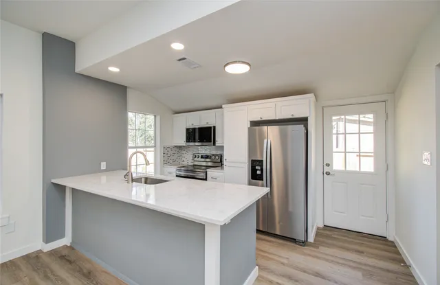a bathroom with a sink a mirror and a shower