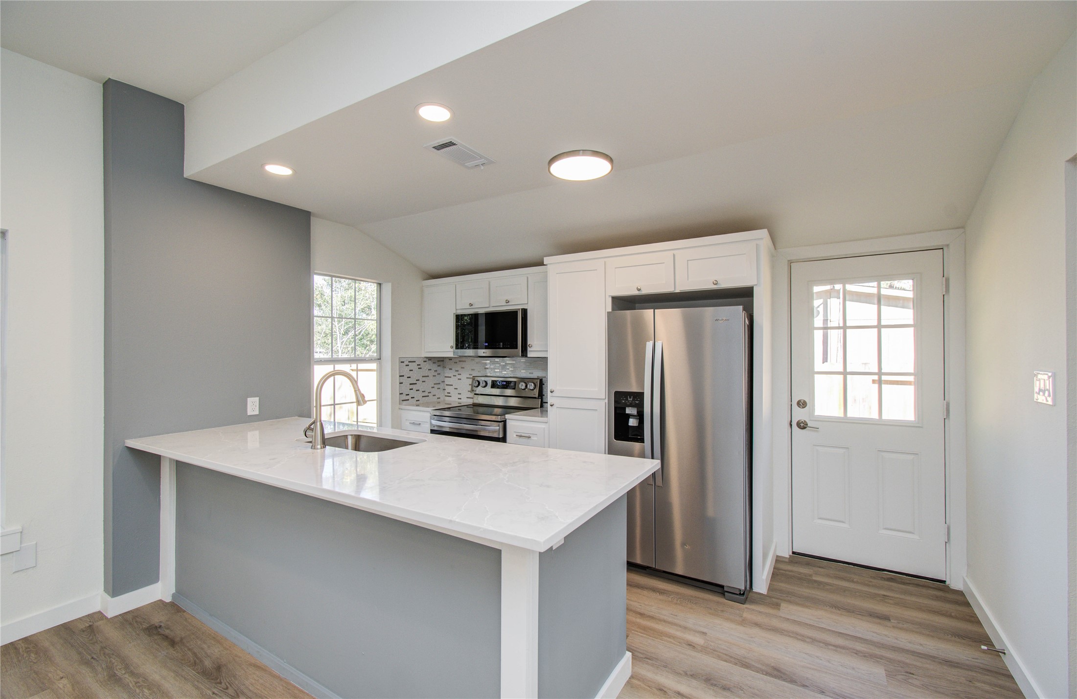 1301 Southgate Drive Rosenberg, TX 77471 - Photo 34 of 49 a kitchen with stainless steel appliances a sink a stove a refrigerator cabinets and a window