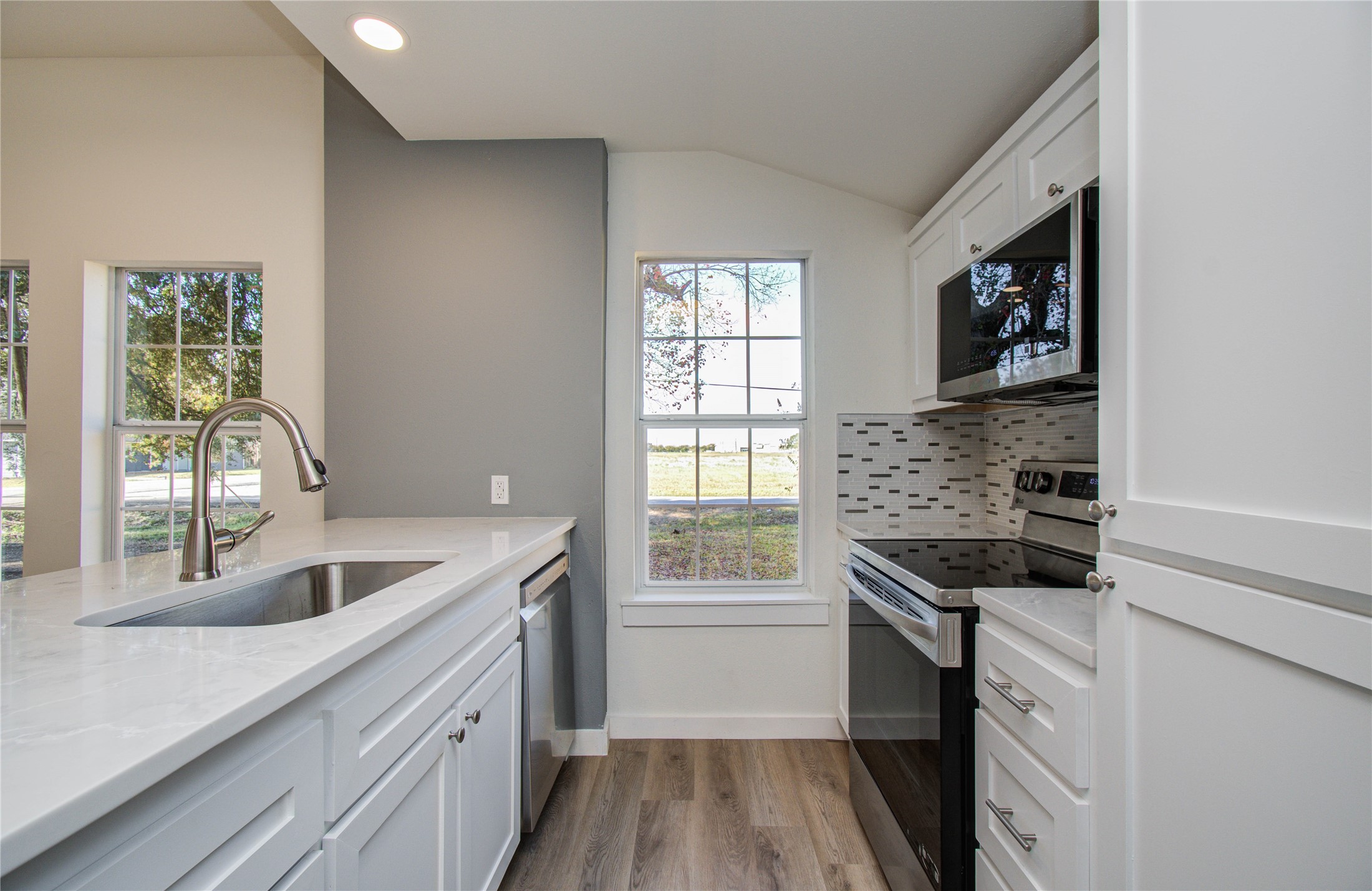 1301 Southgate Drive Rosenberg, TX 77471 - Photo 35 of 49 a kitchen that has a sink and a stove