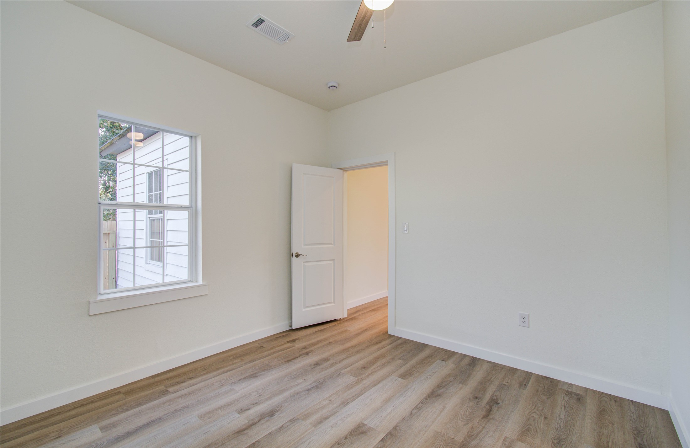 1301 Southgate Drive Rosenberg, TX 77471 - Photo 43 of 49 an empty room with wooden floor and windows
