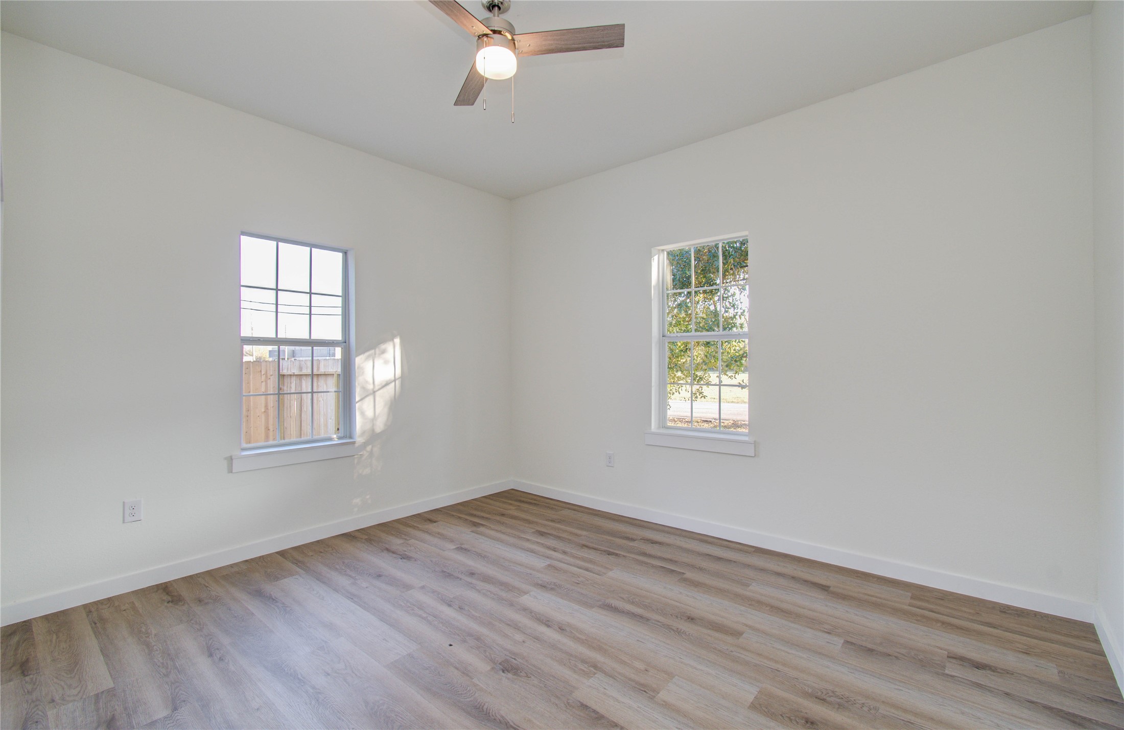 1301 Southgate Drive Rosenberg, TX 77471 - Photo 44 of 49 an empty room with wooden floor and windows