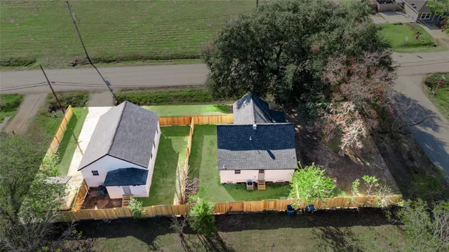 an aerial view of a house with a garden and lake view