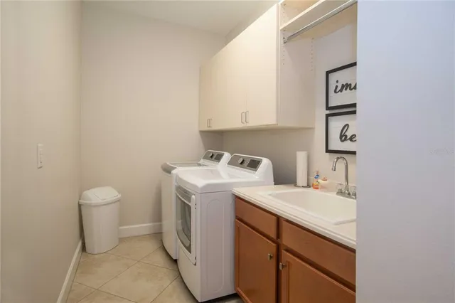 a living room with patio furniture and a floor to ceiling window