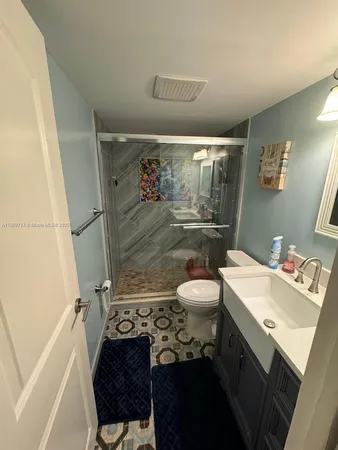 a bathroom with a sink toilet and shower