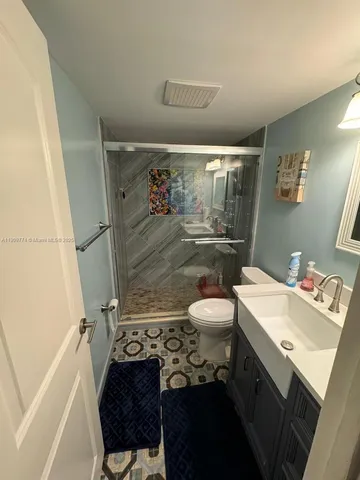 a bathroom with a sink toilet and shower