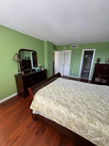 a bedroom with a bed and a television