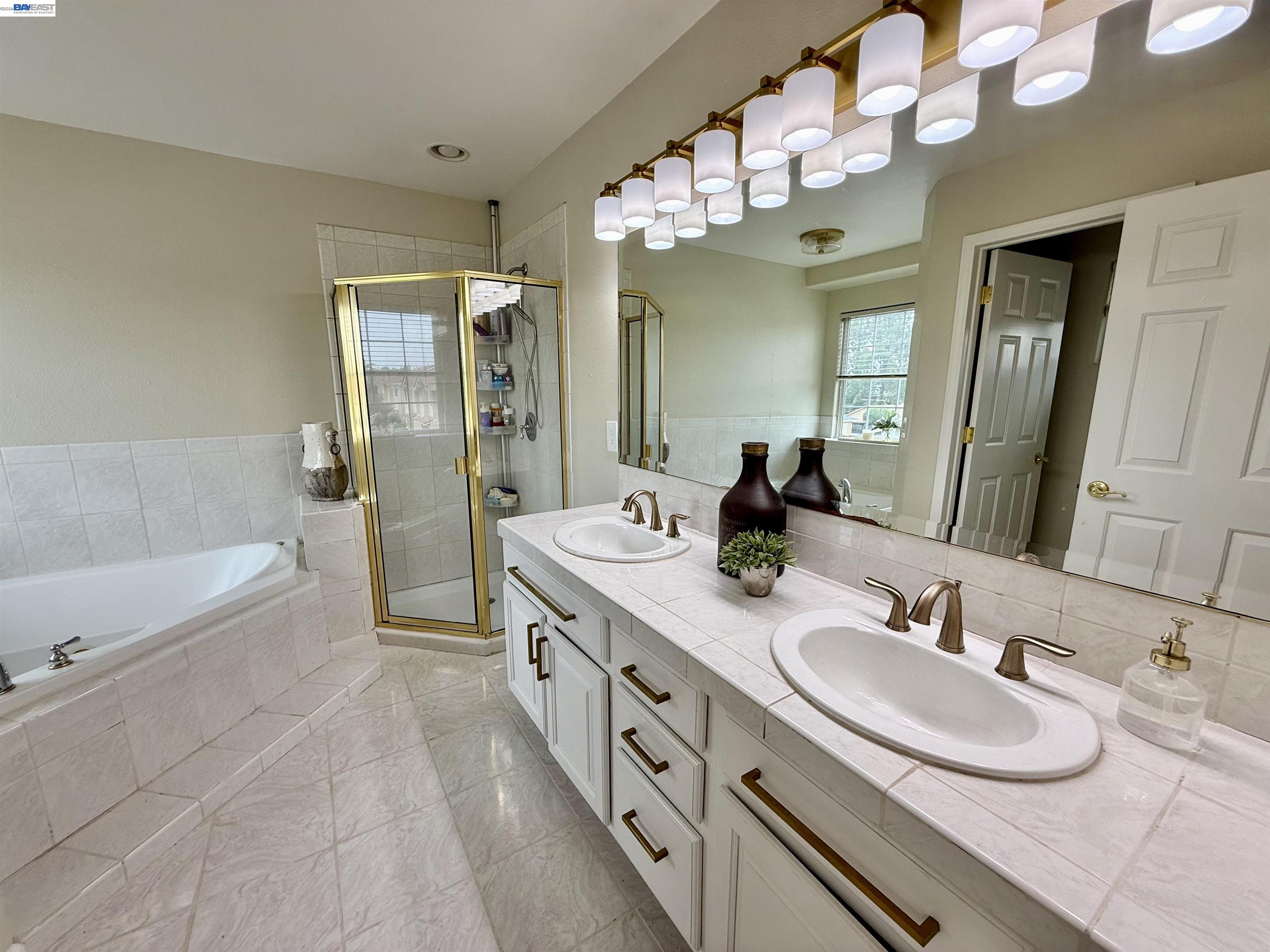 1284 Riesling Circle Livermore, CA 94550 - Photo 51 of 79 a spacious bathroom with a granite countertop sink a mirror a bathtub and shower