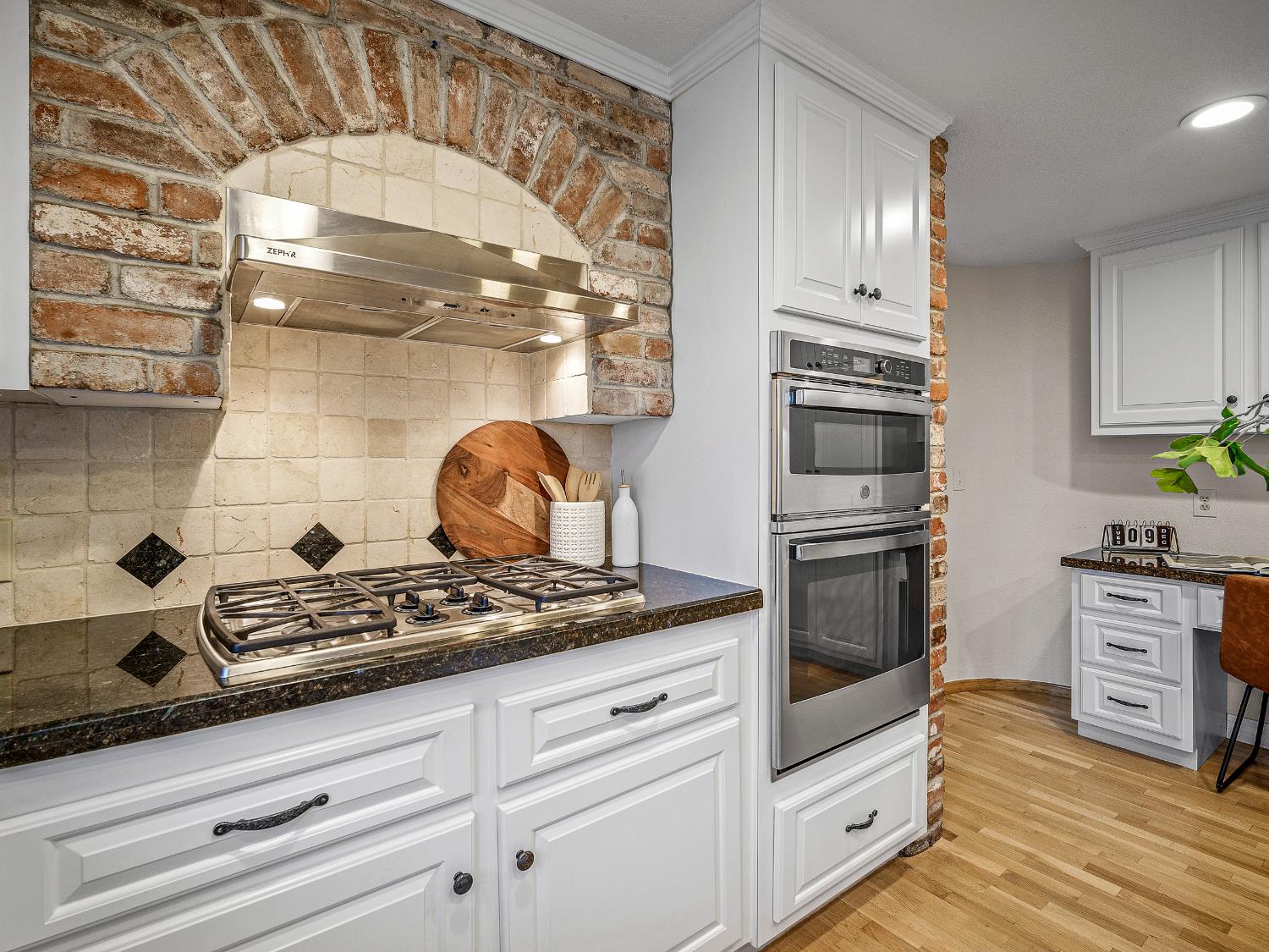 3169 Ridgeview Drive El Dorado Hills, CA 95762 - Photo 24 of 46 a kitchen with granite countertop a stove and a wooden floor